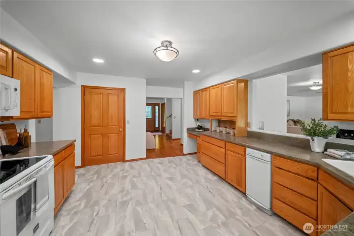 KITCHEN | View from the eat-in area. The door leads to a walk-in pantry. The dining room is through the doorway to the left and the family room is to the right.
