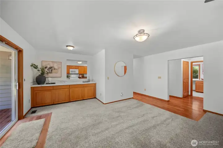 FAMILY ROOM BONUS AREA | With the convenient pass-through from the kitchen this area is the perfect landing spot for snacks or beverages when entertaining in the family room. The doorway to the right leads to the bright, clean laundry room.