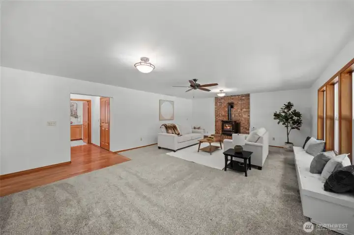 FAMILY ROOM | There is so much space in this home you won't know what to do with it all. This large family room is located at the back of the home with sliding glass door access to the back deck and backyard. Keep cozy in the winter with the cute gas stove.