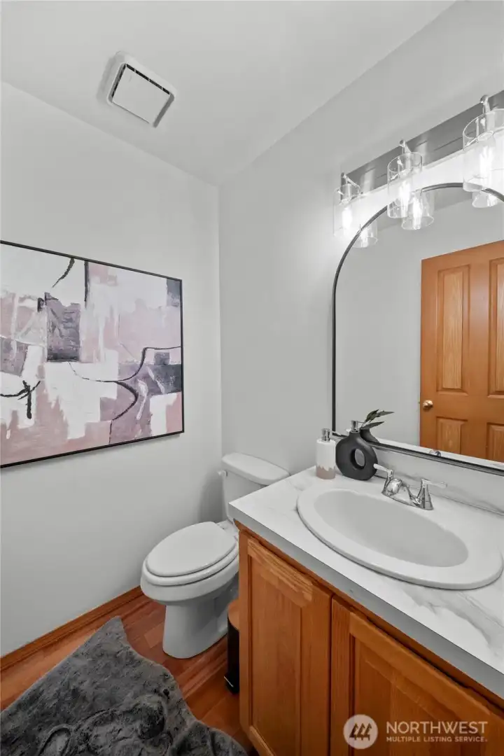 MAIN FLOOR GUEST BATHROOM | Fresh and updated with new paint, new countertop, new sink and new lighting.