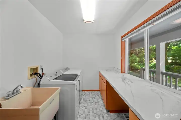 LAUNDRY ROOM | This bright, functional laundry room is located at the front of the home. Notice the fresh paint and new laminate countertops.