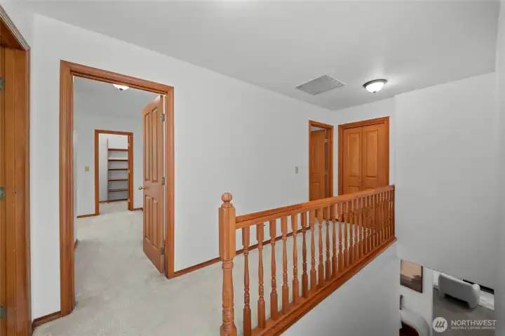 2ND FLOOR | At the top of the stairs, to the right you'll find the primary bedroom and one of the bedrooms connected by a Jack-and-Jill bathrooms.
