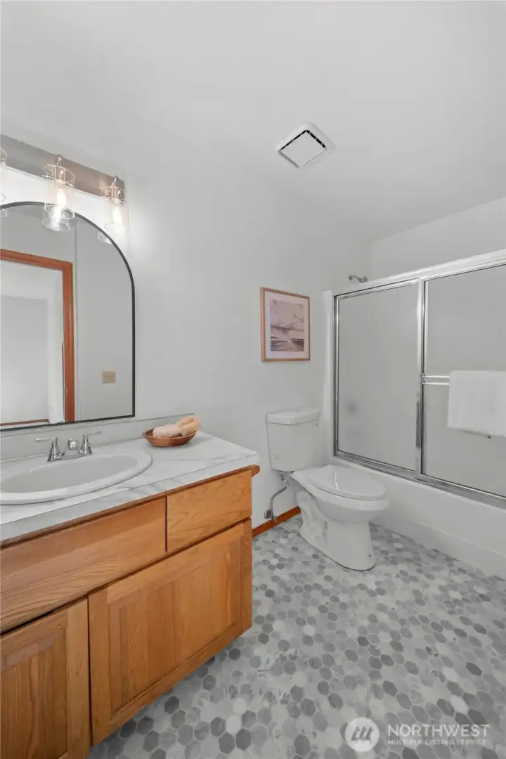 BATHROOM CONNECTED TO BEDROOM 3 | This is the bathroom connected to what we're calling the junior primary bedroom. New lighting, new countertops, new sink, new flooring, new toilet!