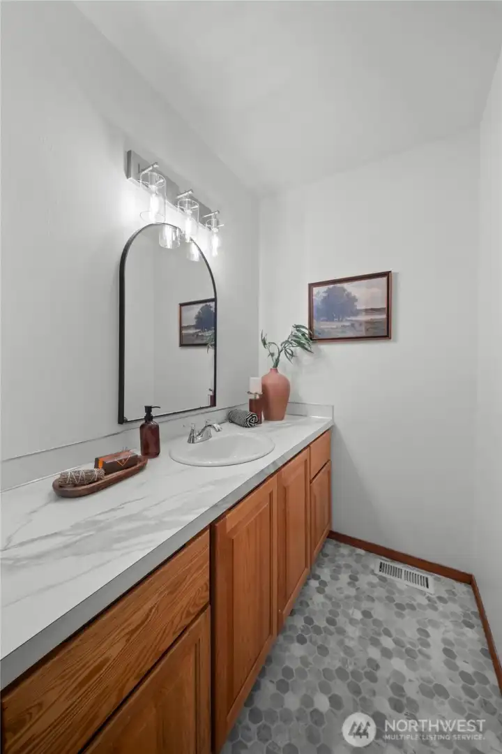 2ND FLOOR JACK-AND-JILL BATHROOMS | Each bedroom connects to a vanity with the shower and toilet in the middle. New lighting, countertops, and flooring.