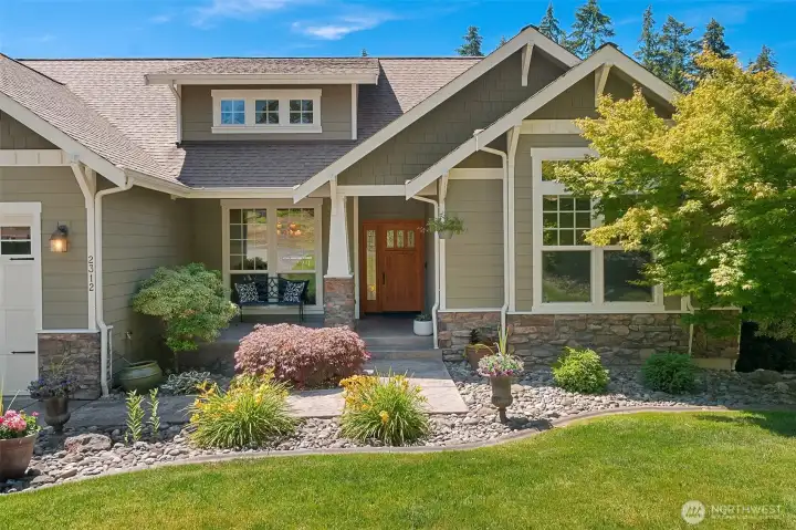 Low-maintenance landscaping, an 11-zone sprinkler system, and beautifully established plantings create an inviting, polished approach that makes the arrival every bit as memorable as the home itself. Low-maintenance landscaping, an 11-zone sprinkler system, and beautifully established plantings create an inviting, polished approach that makes the arrival every bit as memorable as the home itself.