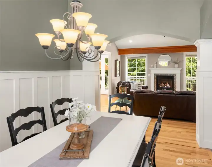 Beneath the graceful arch, your first glimpse of the formal living room reveals a premium Napoleon fireplace framed by dramatic floor-to-ceiling windows on both sides, creating a striking focal point filled with natural light. Beneath the graceful arch, your first glimpse of the formal living room reveals a premium Napoleon fireplace framed by dramatic floor-to-ceiling windows on both sides, creating a striking focal point filled with natural light.
