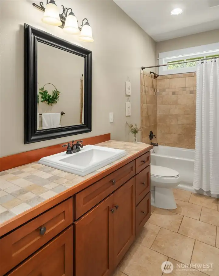 The main hall bath is also conveniently located on the main floor, with a raised-lip sink and finishes so pristine it is hard to believe the home has ever been lived in. The main hall bath is also conveniently located on the main floor, with a raised-lip sink and finishes so pristine it is hard to believe the home has ever been lived in.