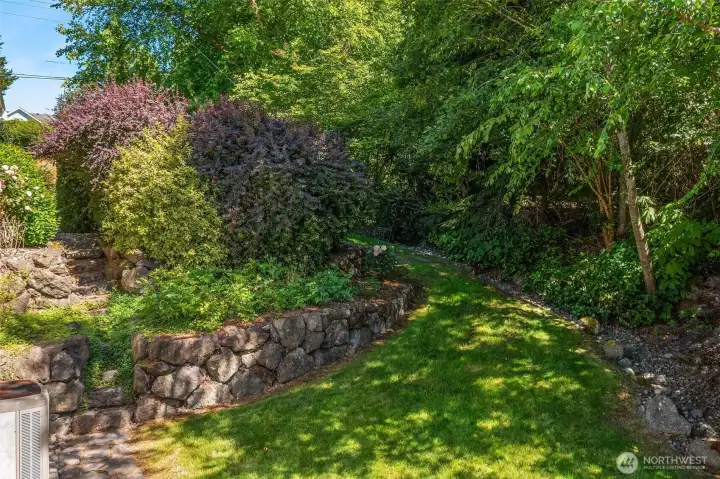 Multiple landscaped terraces and beautifully established plantings surround you at every turn, creating a backyard that is layered, private, and simply gorgeous. Multiple landscaped terraces and beautifully established plantings surround you at every turn, creating a backyard that is layered, private, and simply gorgeous.
