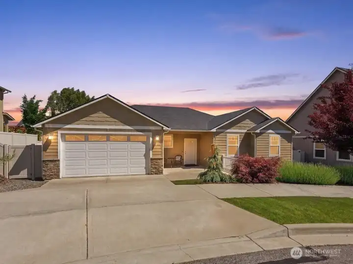 Beautifully maintained single-level home with inviting curb appeal, covered front porch, mature landscaping, irrigation, and stunning Saddle Rock views.