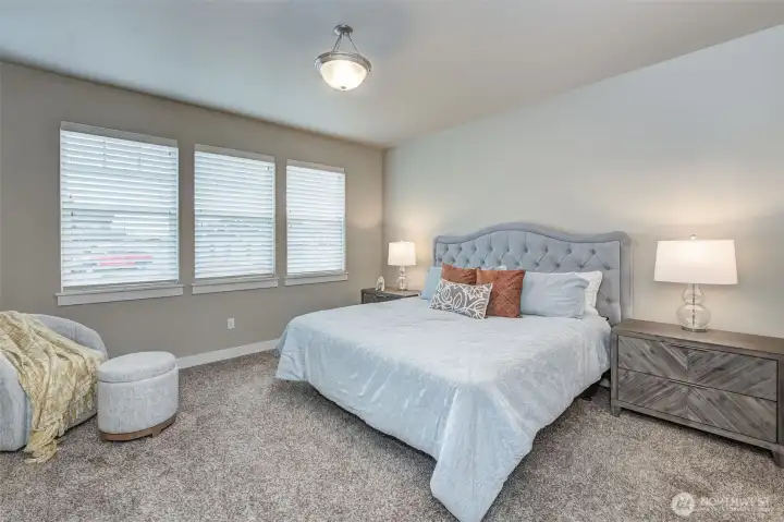 Spacious primary bedroom tucked away in a split-bedroom floor plan for added privacy.