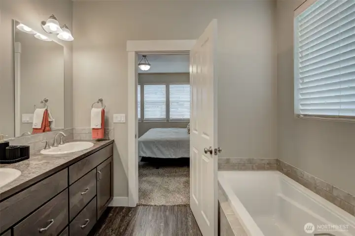 Unwind in the luxurious 5-piece primary bath complete with a soaking tub, separate shower, dual sinks, and generous counter space.