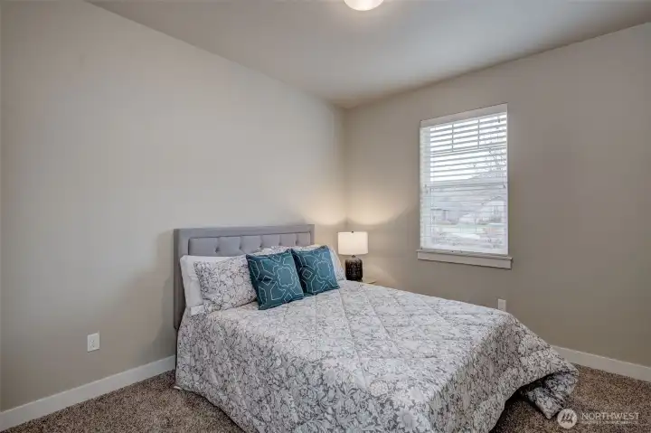 Bright additional bedroom with ample closet space and natural light.