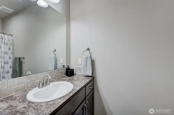 Convenient full bathroom serving the secondary bedrooms and guests.