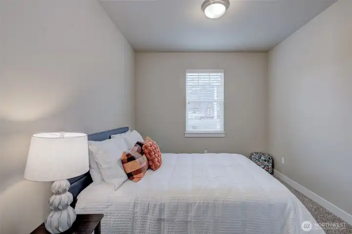 Versatile third bedroom offering abundant natural light, generous closet space, and flexibility as a guest room, home office, craft room, or fitness space.