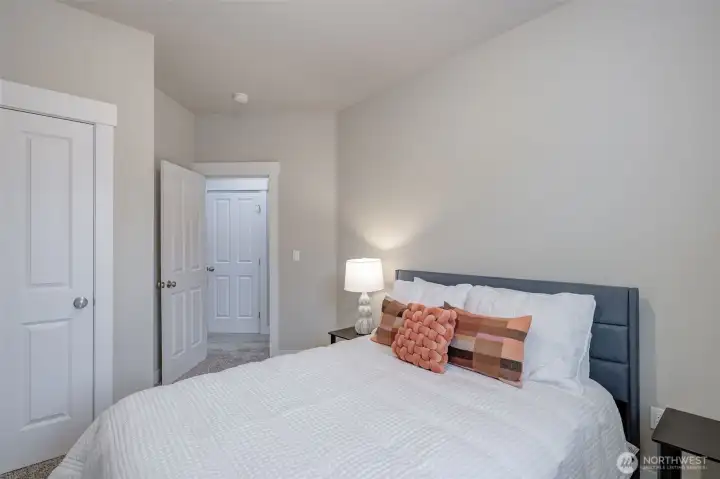 Comfortable third bedroom with a spacious closet and bright window, ideal for guests, remote work, hobbies, or additional living space.