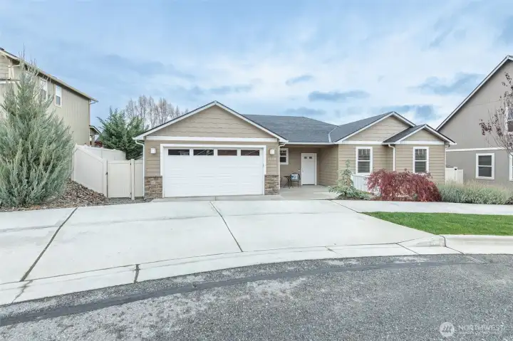Beautifully maintained single-level home with inviting curb appeal, covered front porch, mature landscaping, irrigation, and picturesque Saddle Rock views.