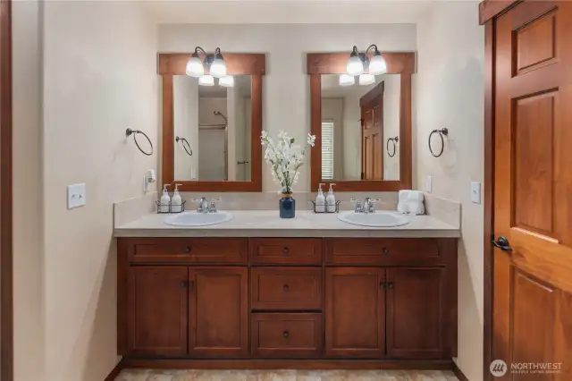 Thoughtfully designed luxurious primary suite features a custom 5-piece bath complete with a spa-like soaking tub, dual vanities, a walk-in shower, and a custom-tailored bidet.