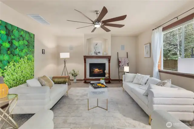 Light-filled, this oversized living room features a cozy gas fireplace and soaring ceilings anchored by two tall picture windows that frame serene views of the private yard and lush greenbelt. A perfect space for gatherings or quiet moments at home