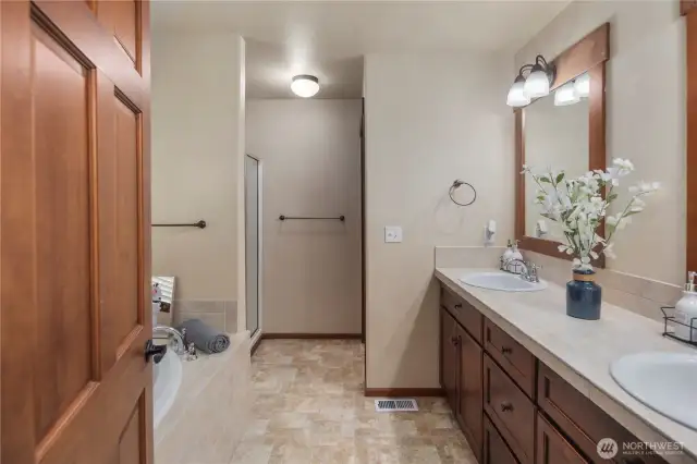 The primary bath offers a serene retreat with dual sinks, a soaking tub, a separate shower, and a custom bidet. Positioned to face east, you can enjoy beautiful morning light with complete privacy—no one looking in