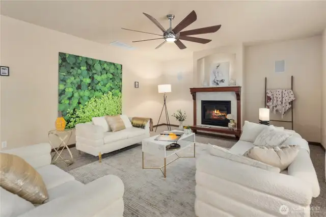 Light-filled, this oversized living room features a cozy gas fireplace and soaring ceilings anchored by two tall picture windows that frame serene views of the private yard and lush greenbelt. A perfect space for gatherings or quiet moments at home