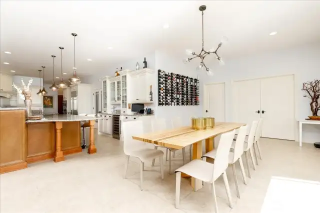 Kitchen eating space with wall wine rack. Separate formal dining room adjacent to the foyer