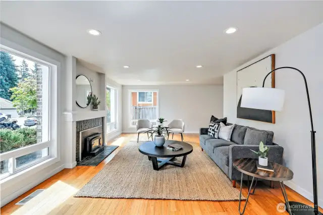 Natural lighting in this large living room with wood fireplace