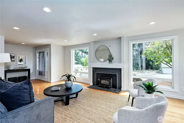 Living room and wood fireplace.  Check out the large windows