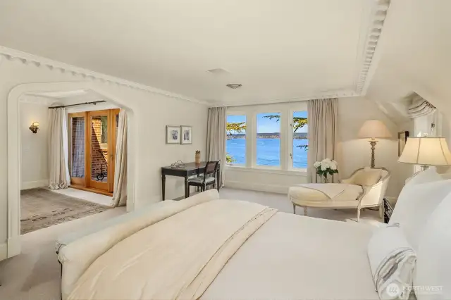 Upstairs enjoy the primary suite with private balcony and sweeping views.