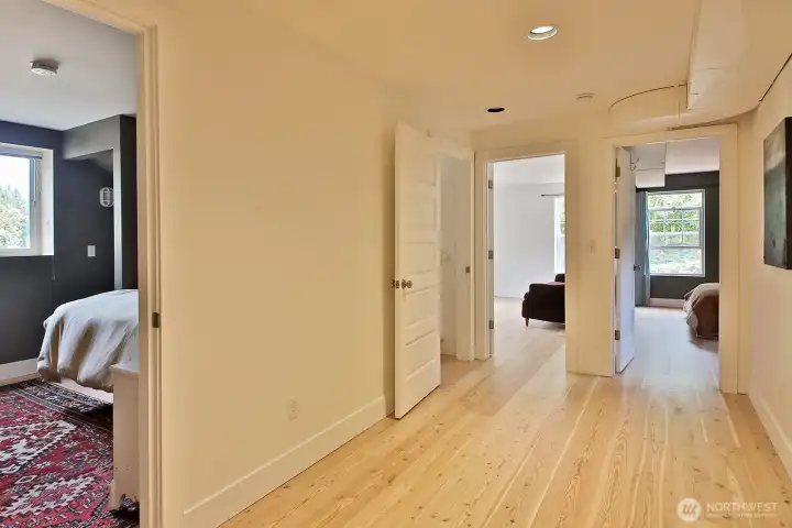 You are now on the lower level. Localy milled fir floors have just been installed. Guest Room to the left, Bedrooms 2 (right) & 3 (left) are straight ahead. Bath is along the right edge of this photo.