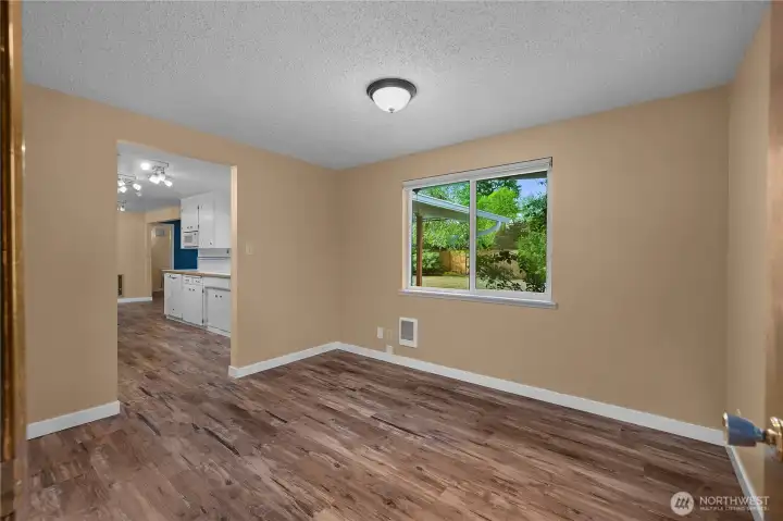 This versatile room offers a bright backyard view and easy kitchen access, making it ideal as a dining area or flexible space for your needs.