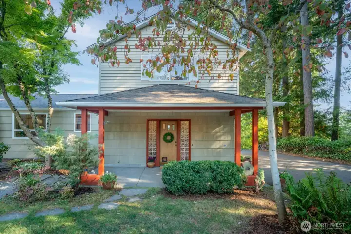 The rear entrance, tucked privately at the back, serves as the home’s main entry.