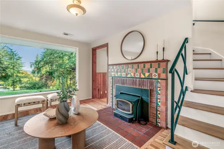 Charming tiled fireplace with wood stove and insert. If the power goes out you can still have heat from the wood burning fireplace. Enjoy views of the Cascade Mountains out the front window. Stairs lead up to the Primary Suite.