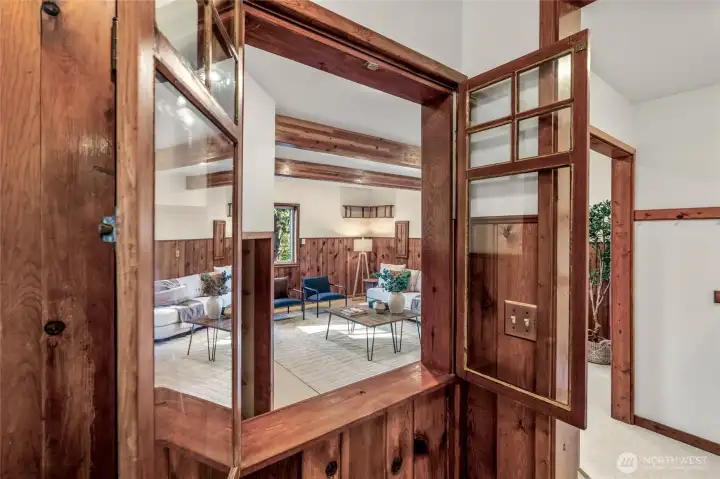 Pass-through with beautiful wood doors opens to the family room. This home is full of character and timeless period touches!