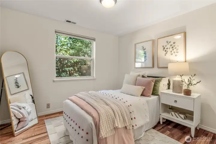 Middle bedroom downstairs. Original hardwood floors make this room feel cozy.