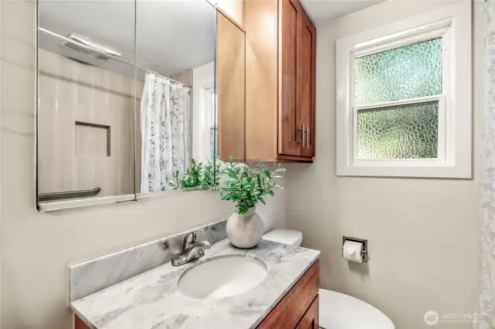 Guest Bath downstairs has full tub/shower combo.