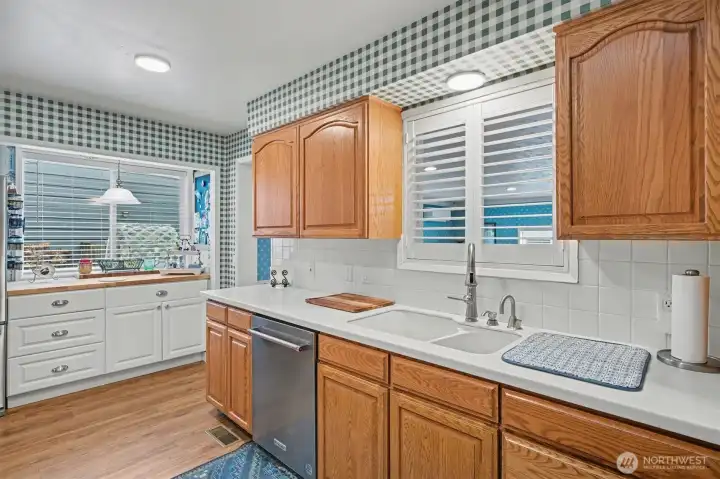 Stainless Steel Appliances. Tile Backsplash. Solid Surface Counters.