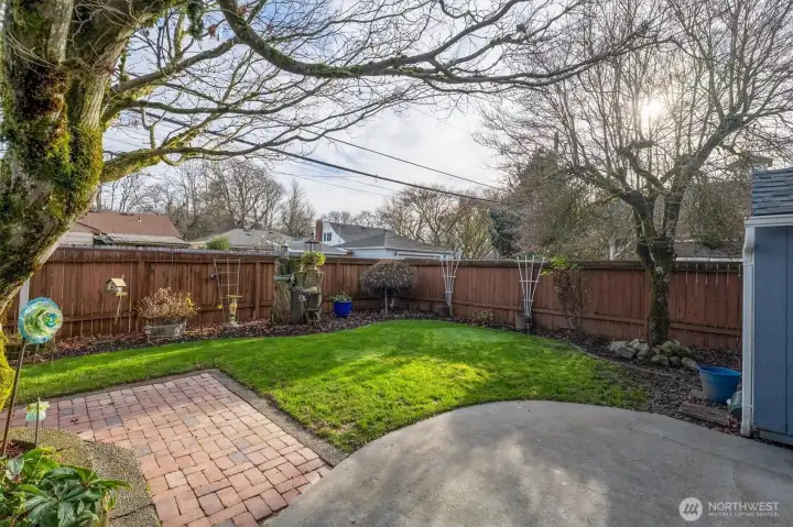 Patio and Back Yard w/ Mature Plantings.