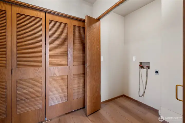 Water heater closet with new water heater and hookups for washer and dryer