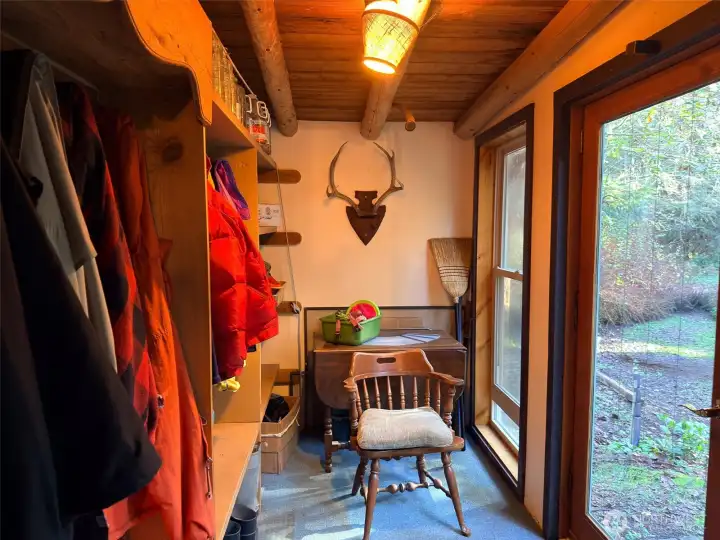 Enter through the French doors to a very functional mud room with plenty of space to hang coats & hats and store boots and shoes.