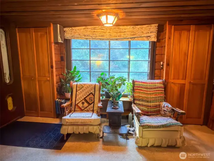 Large living room window framed by two shelving closets.