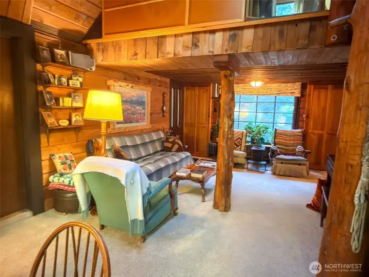 Living room showing the door to front entry/mud room on left.