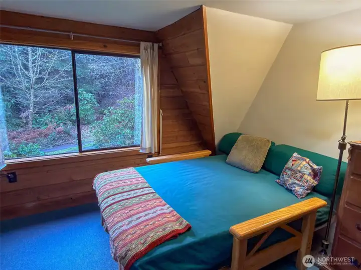 Guest/day bed has a picturesque view to the outside.