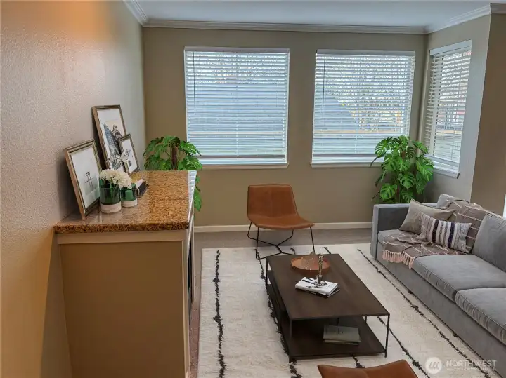 Light-filled living area with oversized windows, neutral palette, and an open-concept layout ideal for entertaining.