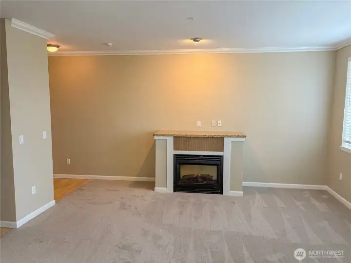 Alternate living room view highlighting fireplace detail and flexible furniture placement.