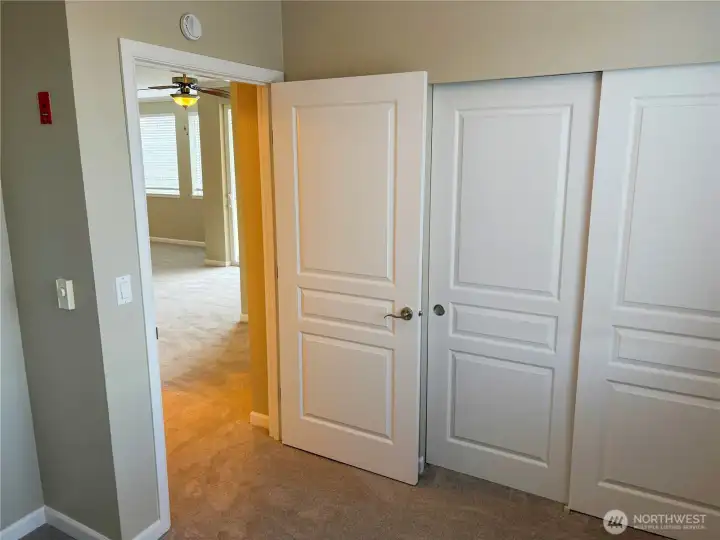Bedroom entry with dual closets offering excellent storage solutions.
