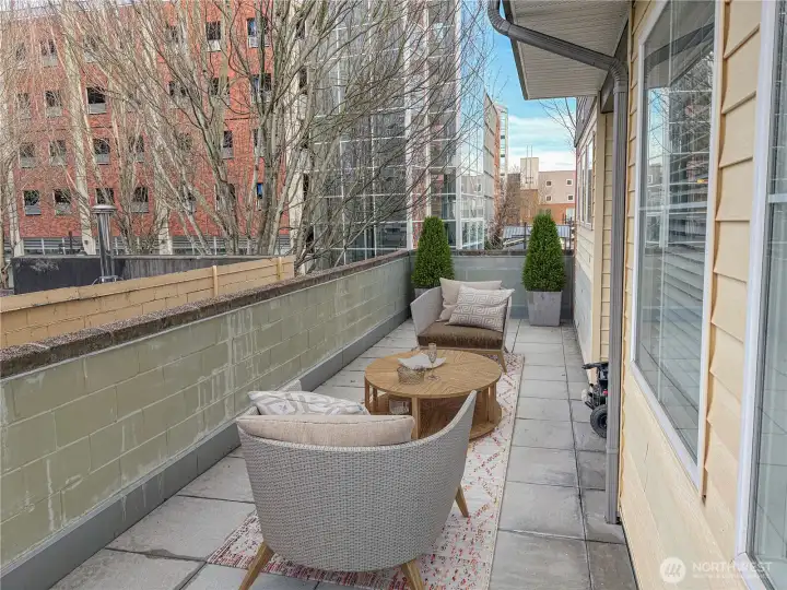 (Virtually Staged) Private patio space ideal for outdoor seating, morning coffee, or entertaining guests.
