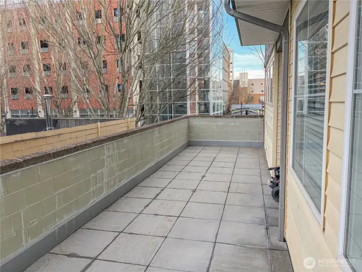 Expansive patio showcasing urban outdoor living rarely found in downtown condominiums.