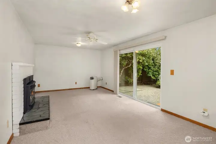 Bonus room with a portable AC unit and gas fireplace.