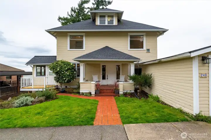 Classic 1908 American Foursquare with inviting front porch and timeless South Hill charm.