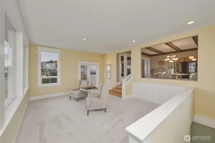 Light-filled sitting area with new carpet and picture windows capturing stunning bay views